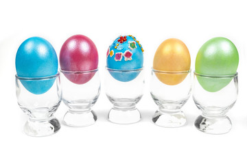 colorful eggs in glass on white