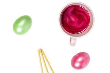 colorful eggs and cup on white