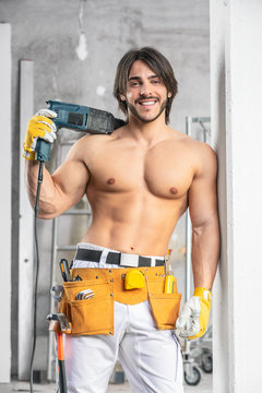 Smiling sexy muscular builder posing shirtless