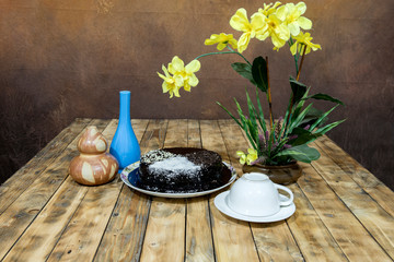 Moisture cake with topping chocolate, dry coconut with decoration on the wooden table, selective focus.