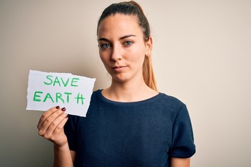 Young beautiful woman holding paper asking for save earth and enviroment conservation with a confident expression on smart face thinking serious