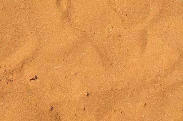 Closeup of sand pattern of a beach in the summer