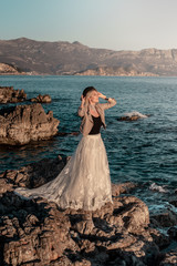 Woman on the sea in white long dress