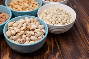 Mix of nuts on a table. Walnuts, almonds, pistachios, cashews, peanuts