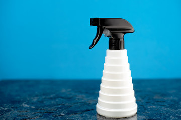the Barber spray gun is located on a black marble slab, with a black and white collar on a blue...