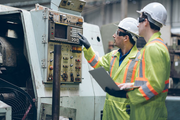 technician engineer and mentor operate machine to automated CNC in factory
