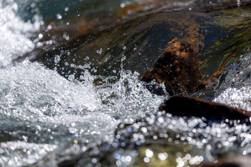 Water mountain river and the wonderful rocky creek. Water Drops after splash. Closeup macro view