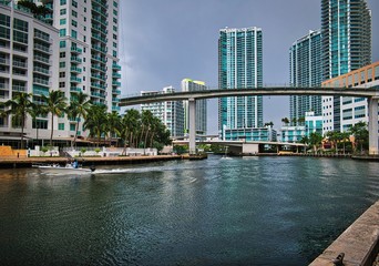 Fototapeta na wymiar View of the Miami River and metrorail overpass with modern buildings