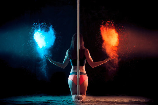 girl next to the pole throws flour on a black background