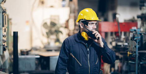 engineers inspector using walkie talkie to command in factory