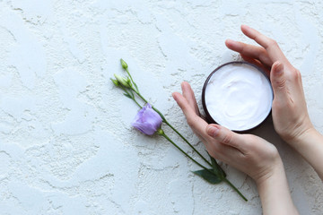 Women's hands hold a jar of cream, the view from above
