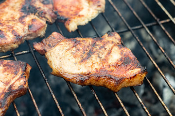 Steak ribi black angus grilled stripes smoke steam charcoal frying. Big raw piece of meat from beef to black metal lattice for frying