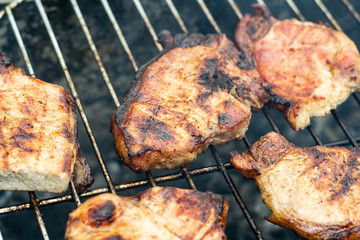 Steak ribi black angus grilled stripes smoke steam charcoal frying. Big raw piece of meat from beef to black metal lattice for frying