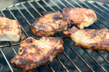 Steak ribi black angus grilled stripes smoke steam charcoal frying. Big raw piece of meat from beef to black metal lattice for frying