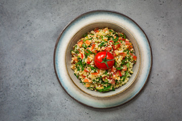 Tabouli or tabbouleh salad with bulgur, tomatoes, lime, mint, parsley