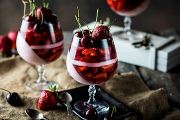 Milk dessert with cherry and strawberry. Milk jelly. Yougurt dessert. Raw food. Panna cotta. Strawberry dessert. Berry dessert. Mousse.