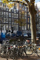 Fototapeta na wymiar Bikes parked near an Amsterdam canal in autumn