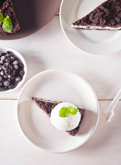 Creamy cheesecake with chocolate, black currant, ice cream and mint leaf for decoration