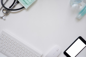 Top view white office desk table with the office equipments, alcohol sanitizer, face mask and other office supplies on the modern space, flat lay.work at home.