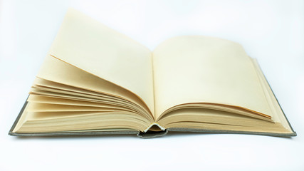 Open yellowed book with blank pages on white background. 