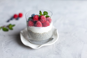 Jar with vanilla chia pudding topped with freezed berries