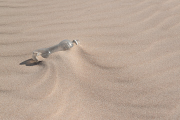 Plastic bottle in the sand, causing pollution at Poço beach, near the city of João Pessoa, Paraíba, Brazil on September 29, 2012