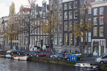 Fototapeta na wymiar A view of an Amsterdam canal with boats parked