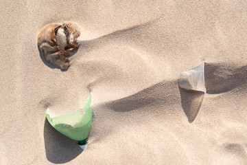 Fototapeta na wymiar Plastic bottle in the sand, causing pollution at Poço beach, near the city of João Pessoa, Paraíba, Brazil on September 29, 2012
