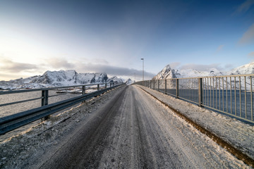 Bridge against snowcapped mountains in Reine, Norway