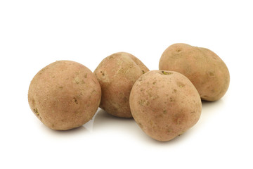 Freshly harvested potatoes on a white background