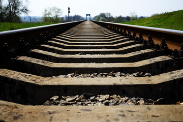 Rails and beams on the railway, a bridge in the distance