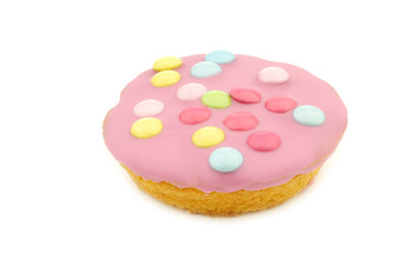 festive cake with pink icing and colorful sprinkles on a white background