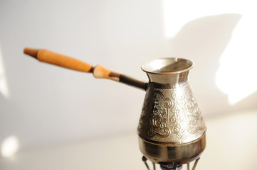 Cezve coffee brewing on gas-burner. White background