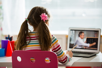Middle-aged distance teacher having video conference call with pupil using webcam. Online education...