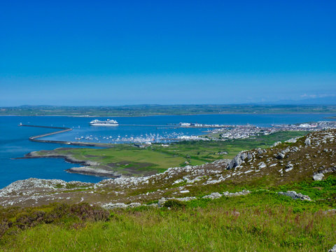 On a summer day with blue skies, a ferry to Ireland sails from the port of Holyhead on the island of Anglesey in North Wales.