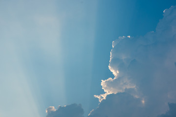 The sky is beautiful, with clouds and rays from the Buddha amulets shining into light beams.