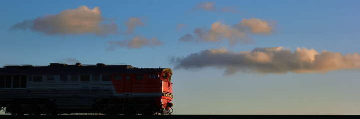 train locomotive rides against a blue sky