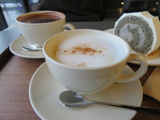 Latte with hot chocolate and a slice of cake