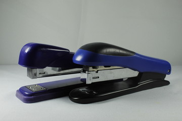 A blue stapler isolated on white