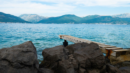 Fototapeta na wymiar Wooden pier for boats Kotor Bay, Montenegro, Europe.