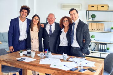 Group of business workers smiling happy and confident in a meeting. Standing with smile on face looking at camera at the office.
