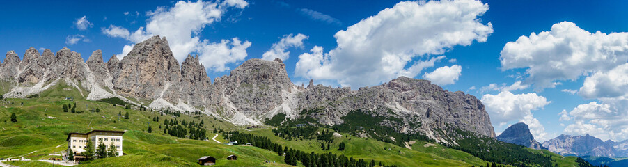Fototapeta na wymiar Panoramic view of magical Dolomite peaks of Pizes da Cir, Passo Gardena during a summer day, South Tyrol, Italy, wide angle