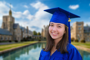 Portrait of attractive young woman in cap and gown after graduation in 2020
