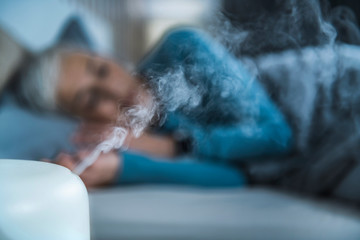 Sleeping with Air Humidifier in Bedroom, Increasing the Humidity for Better Sleep - obrazy, fototapety, plakaty