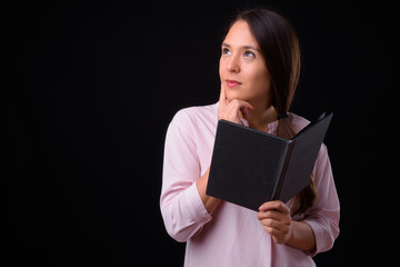 Young multi ethnic beautiful businesswoman against black background
