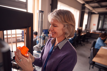 Mature Female College Student Studying Engineering Using 3D Printing Machine