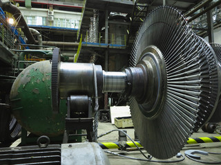 Power generator steam turbine in repair process, machinery, pipes, tubes at power plant © alexrow