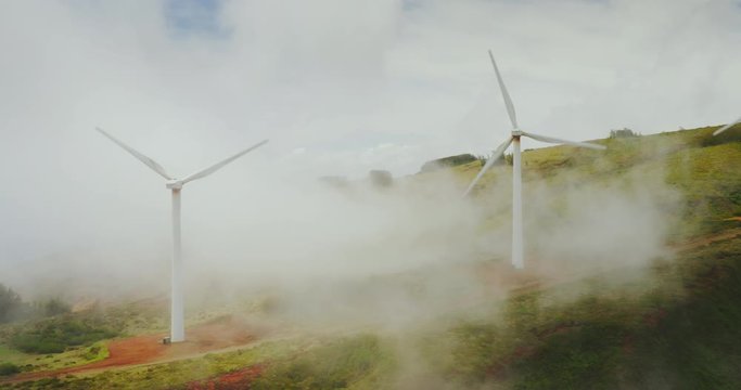 Beautiful cinematic windmills in the mist, clean energy revolution