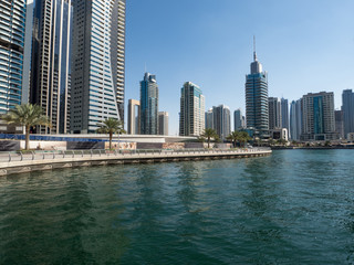 Fototapeta na wymiar February 2020: Promenade and canal in Dubai Marina with luxury skyscrapers around,United Arab Emirates