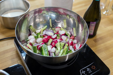 salad in a bowl is on the stove